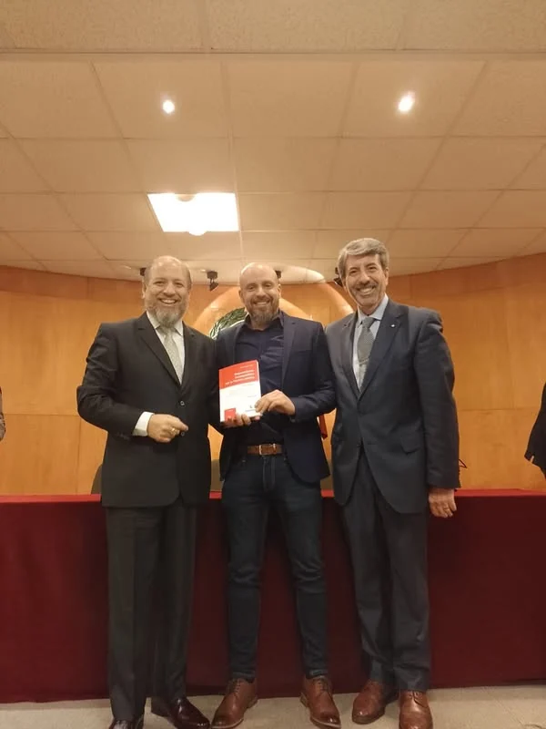 Entrega de un ejemplar durante el encuentro con la editorial Hammurabi.